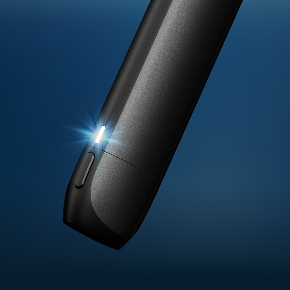 Vuse Ireland A close-up of a sleek black electronic device with a small white LED indicator light illuminated, set against a gradient blue background.