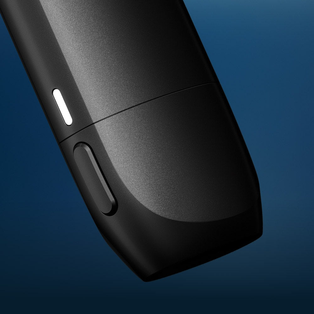 Vuse Ireland A close-up of a sleek, black electronic device with a button and a small white indicator, set against a blue background.