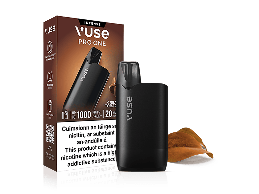 A VUSE Pro One Box Creamy Tobacco rechargeable vape device is positioned in front of its branded packaging, which displays detailed product information. Two brown tobacco leaves are placed next to the device, emphasizing the creamy tobacco flavor of this VUSE Pro One.