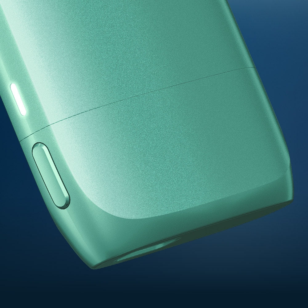 Vuse Ireland Close-up of a sleek, green electronic device with a button and indicator light, set against a dark blue gradient background.