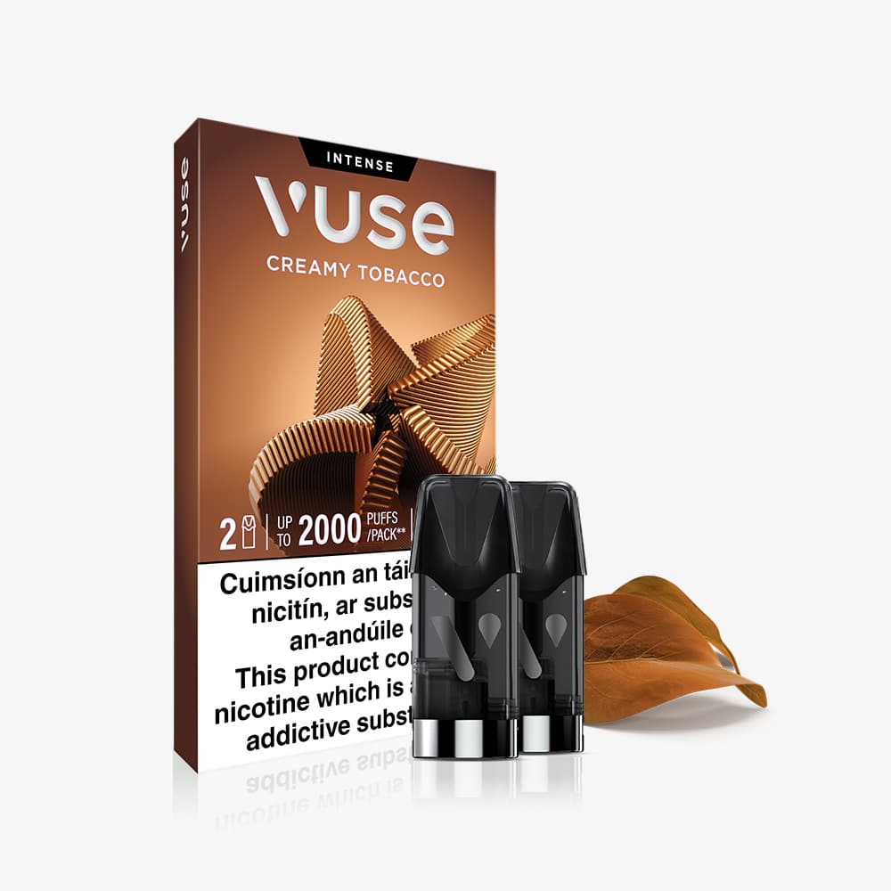 Vuse Ireland The VUSE Pod Creamy Tobacco Extra Intense pack showcases a brown box with abstract patterns, two VUSE PRO pods filled with creamy tobacco e-liquid displayed in front, a brown tobacco leaf accent, and a nicotine warning label in both English and Irish.