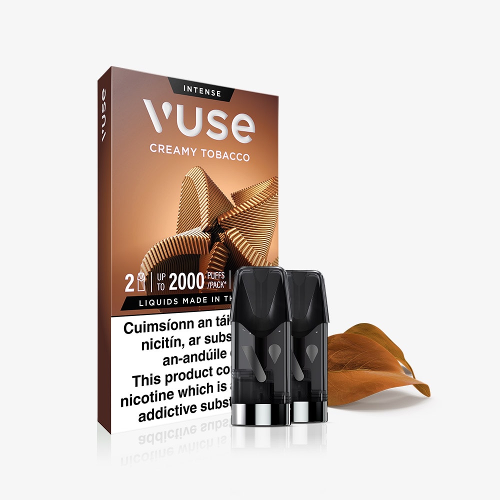 VUSE Pod Creamy Tobacco Extra Intense pack, featuring two pods, comes in a brown box with wavy patterns and is displayed with a tobacco leaf beside the products.
