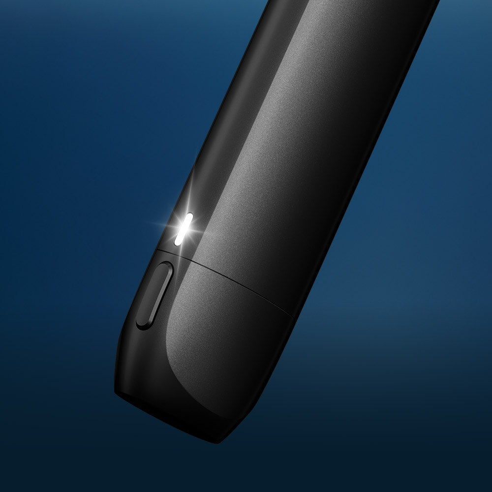 A close-up of the VUSE Vuse Pro One Pen, a sleek black electronic device featuring a small glowing indicator light, set against a blue gradient background.