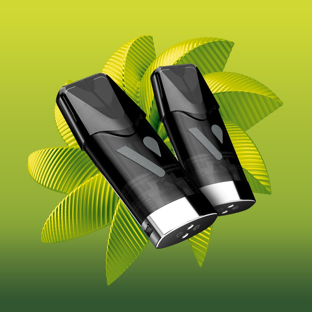 Two sleek black Vuse Lemon & Lime Extra Intense Pods with silver bases are positioned in front of layered green leaves on a gradient yellow-green background, evoking the refreshing essence of lemon and lime nic salts from VUSE.