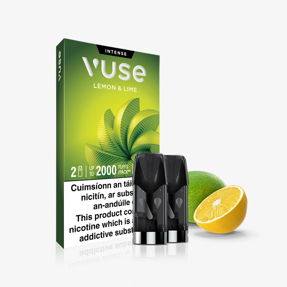 Vuse Ireland VUSE Lemon & Lime Extra Intense vape cartridge pack with two black VUSE Pods in front, accompanied by a whole lime and a sliced lemon against a white background. This vibrant blend delivers bold lemon and lime flavors paired with smooth nic salts for a truly satisfying vaping experience.