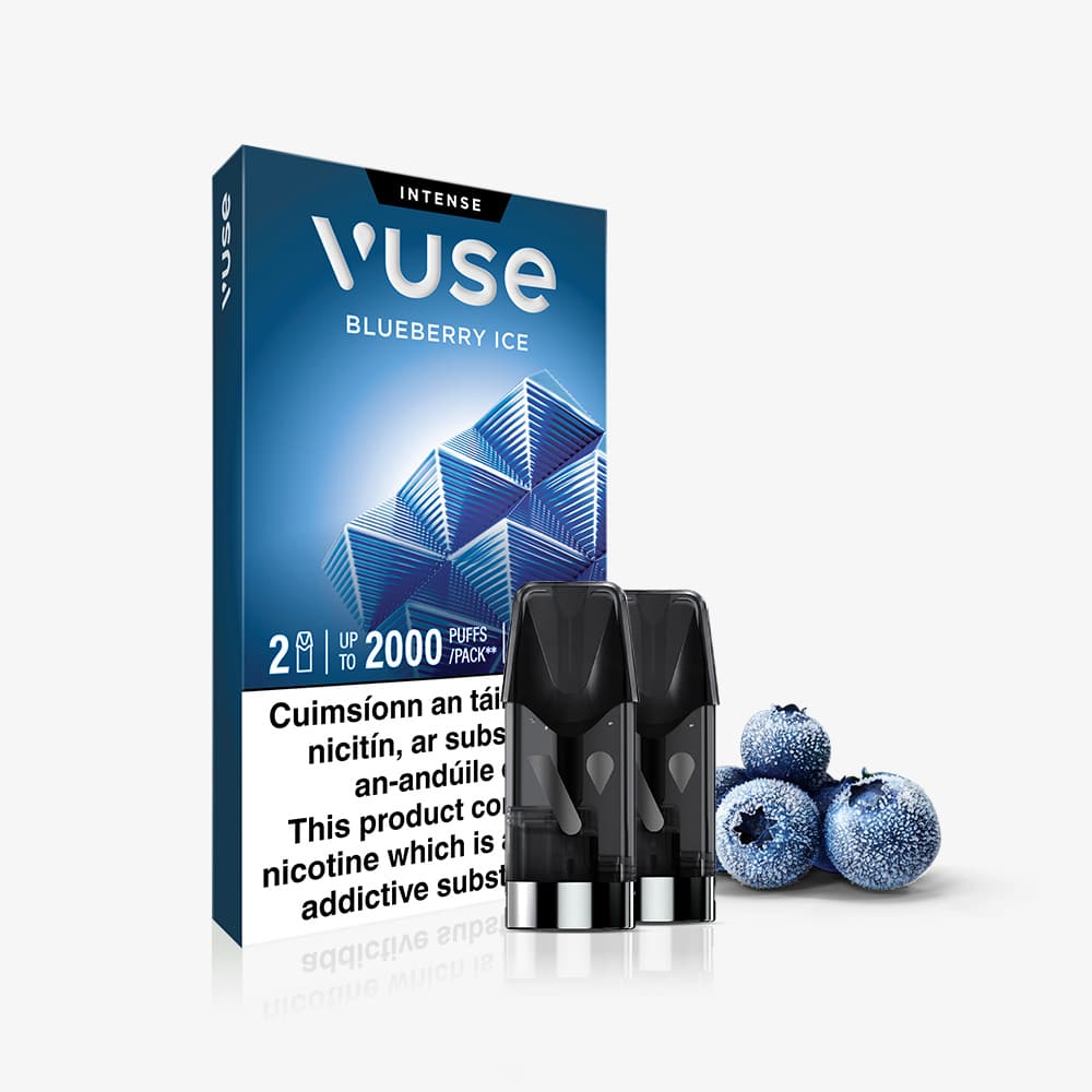 Vuse Ireland The packaging for Vuse Pod Blueberry Ice Extra Intense by VUSE is displayed on a white background, alongside two Blueberry Ice pods and three frosted blueberries. A partial nicotine warning label appears at the bottom.