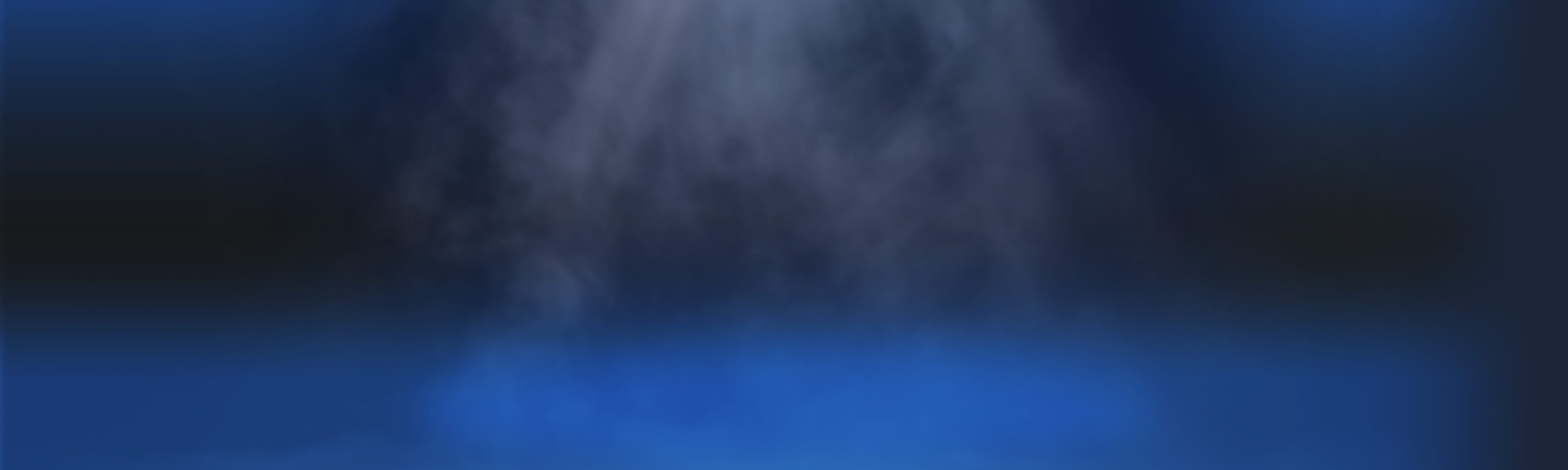 A blue-lit background with mist or smoke rising in the center, illuminated by a soft, focused light from above. The overall atmosphere is dark, mysterious, and dramatic.