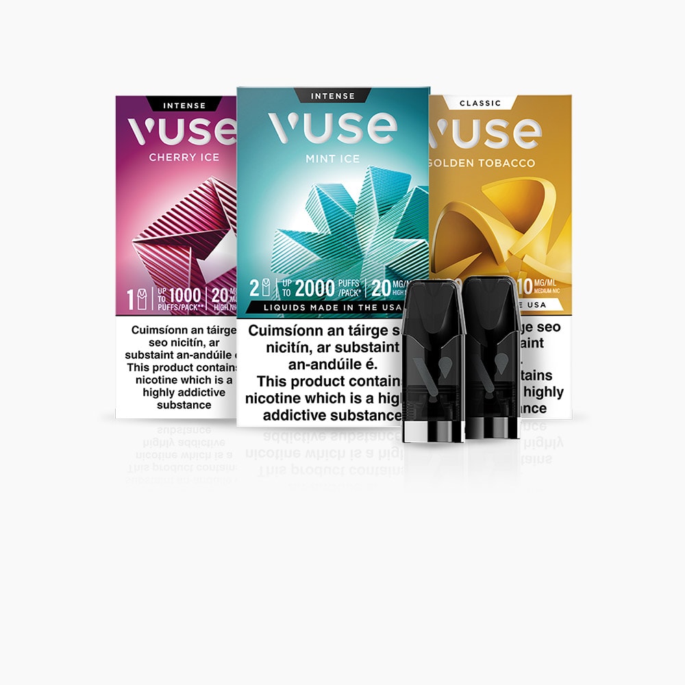Vuse Ireland Three Vuse vape pod packs in Cherry Ice, Mint Ice, and Golden Tobacco flavors are shown behind two black vape pods. Each pack displays flavor, nicotine strength, and warning labels below in English and French.