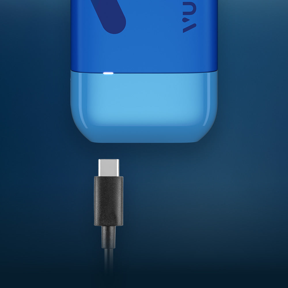 Vuse Ireland A USB-C charging cable is positioned below the charging port of a blue electronic device, ready to be plugged in, against a dark blue background.