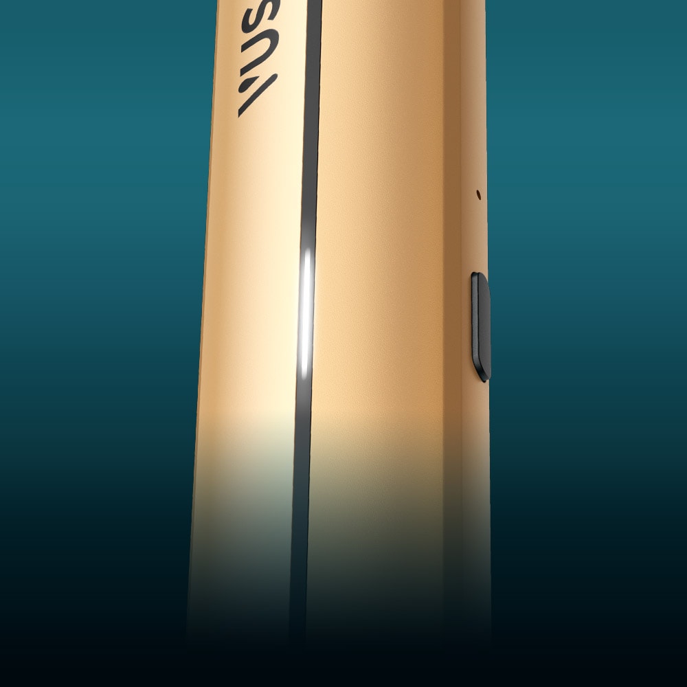 Vuse Ireland Close-up of a gold cylindrical electronic device with a side button and a vertical black stripe, partially visible against a blue gradient background.